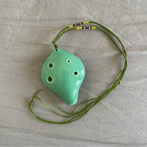 Teal green ocarina flute handheld instrument